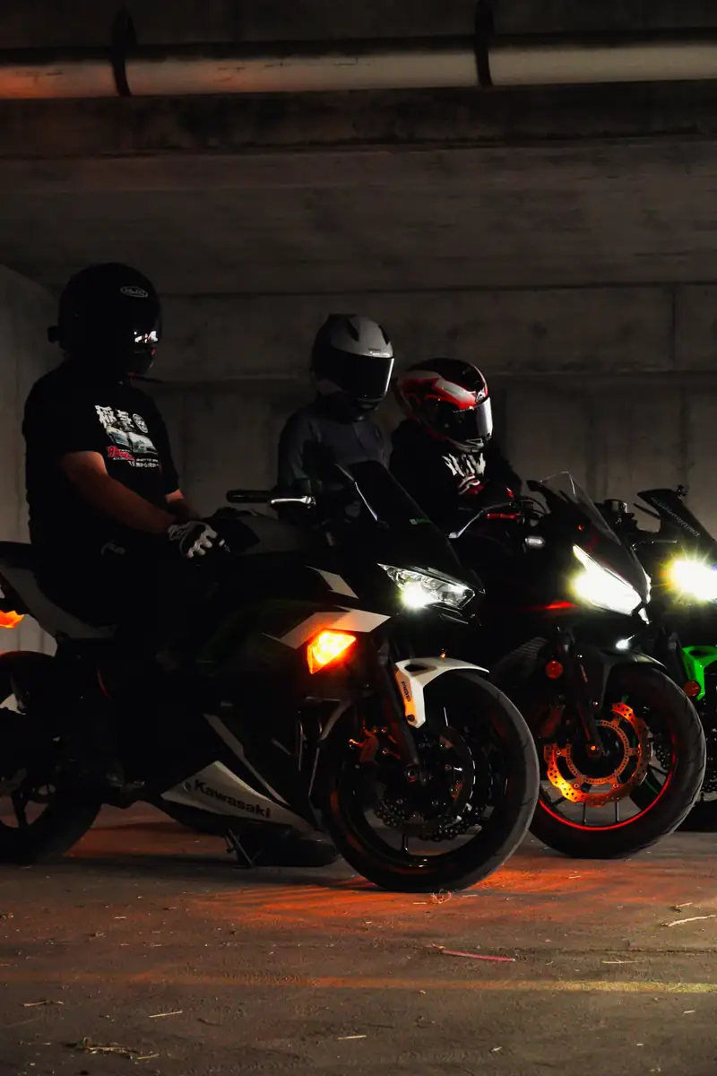 Riders on sport bikes lined up under a parking structure